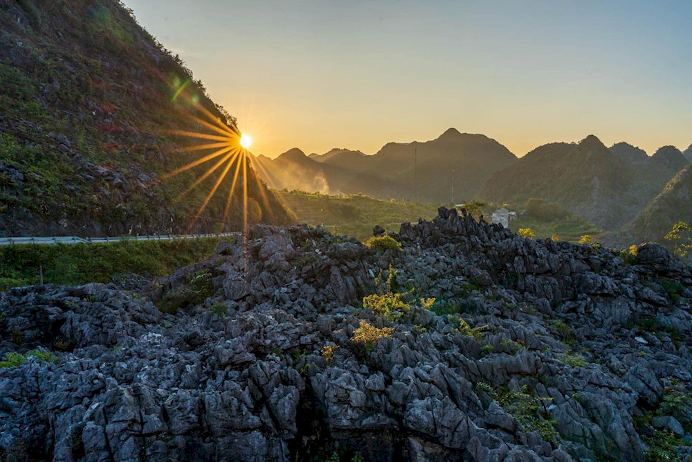 The skywalk bathed in golden light, creating a mesmerizing contrast against the deep valleys below